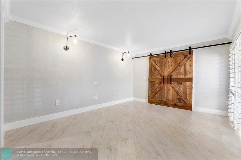 825 Center Street Jupiter, FL 33458 - Photo 15 of 37 a view of an empty room with wooden floor and a window