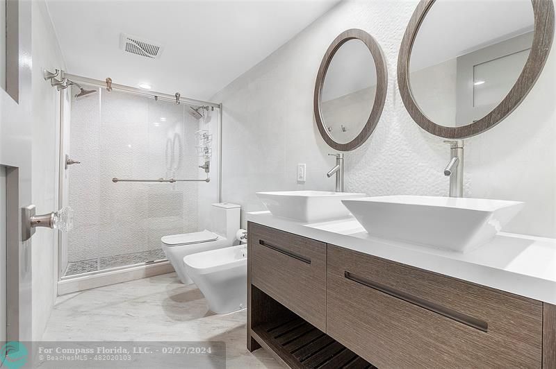 825 Center Street Jupiter, FL 33458 - Photo 17 of 37 a bathroom with a sink a toilet and a mirror