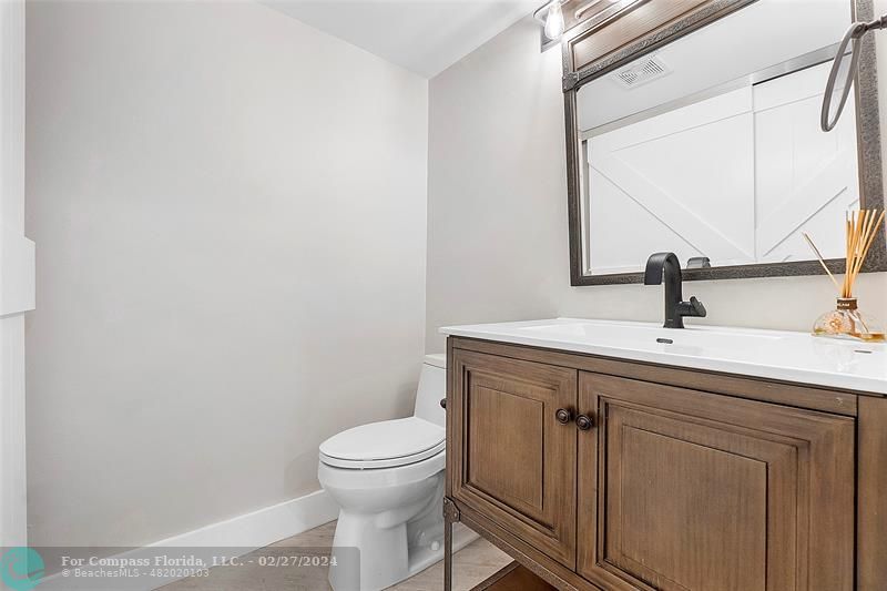 825 Center Street Jupiter, FL 33458 - Photo 23 of 37 a bathroom with a sink a toilet and mirror