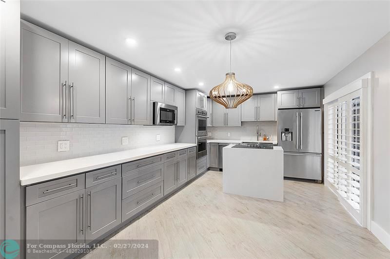 825 Center Street Jupiter, FL 33458 - Photo 9 of 37 a large kitchen with cabinets and stainless steel appliances