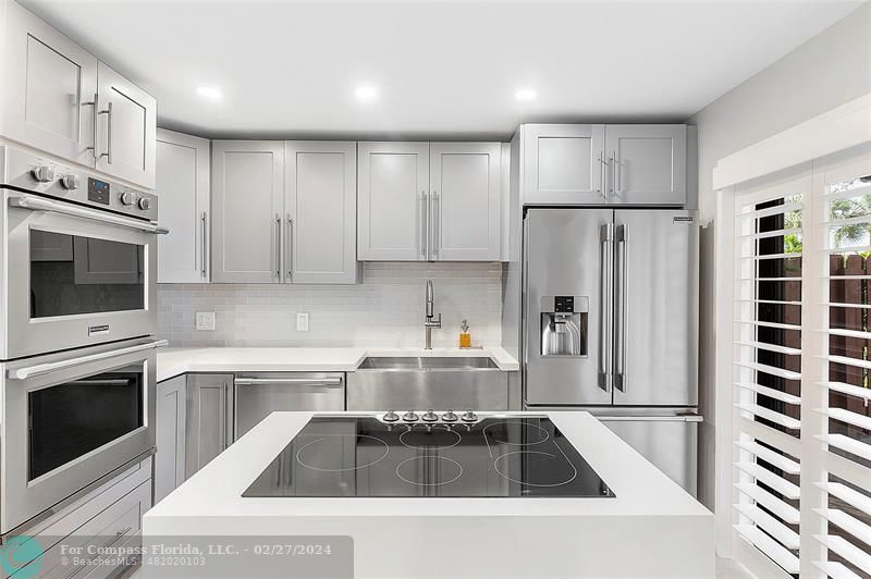 825 Center Street Jupiter, FL 33458 - Photo 10 of 37 a kitchen with stainless steel appliances granite countertop a refrigerator sink and stove