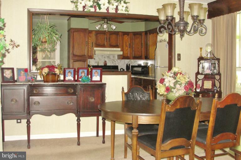 1820 Willann Road Rosedale, MD 21237 - Photo 12 of 27 a kitchen with a dining table chairs and a stove top oven