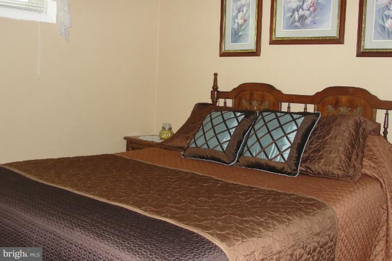 1820 Willann Road Rosedale, MD 21237 - Photo 13 of 27 a bedroom with a bed and wall painting