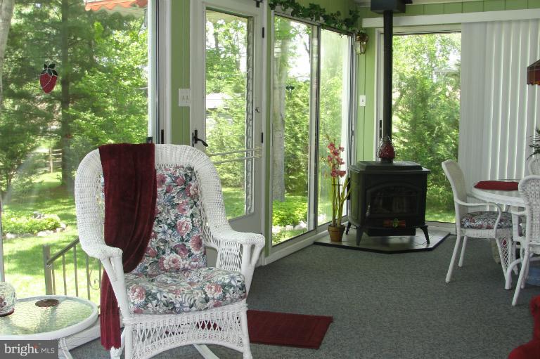 1820 Willann Road Rosedale, MD 21237 - Photo 22 of 27 a living room with a large window and table chairs