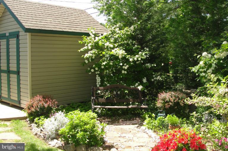 1820 Willann Road Rosedale, MD 21237 - Photo 25 of 27 a yellow house with a flower garden