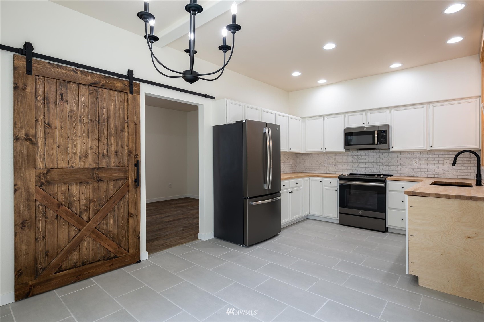 1305 Boon Street, Unit 122 Sumas, WA 98295 - Photo 13 of 21 a kitchen with stainless steel appliances granite countertop a refrigerator and a stove top oven