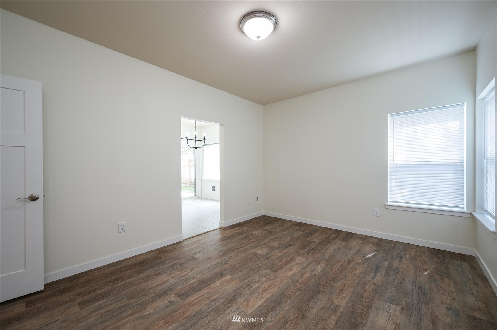 1305 Boon Street, Unit 122 Sumas, WA 98295 - Photo 16 of 21 an empty room with wooden floor and windows
