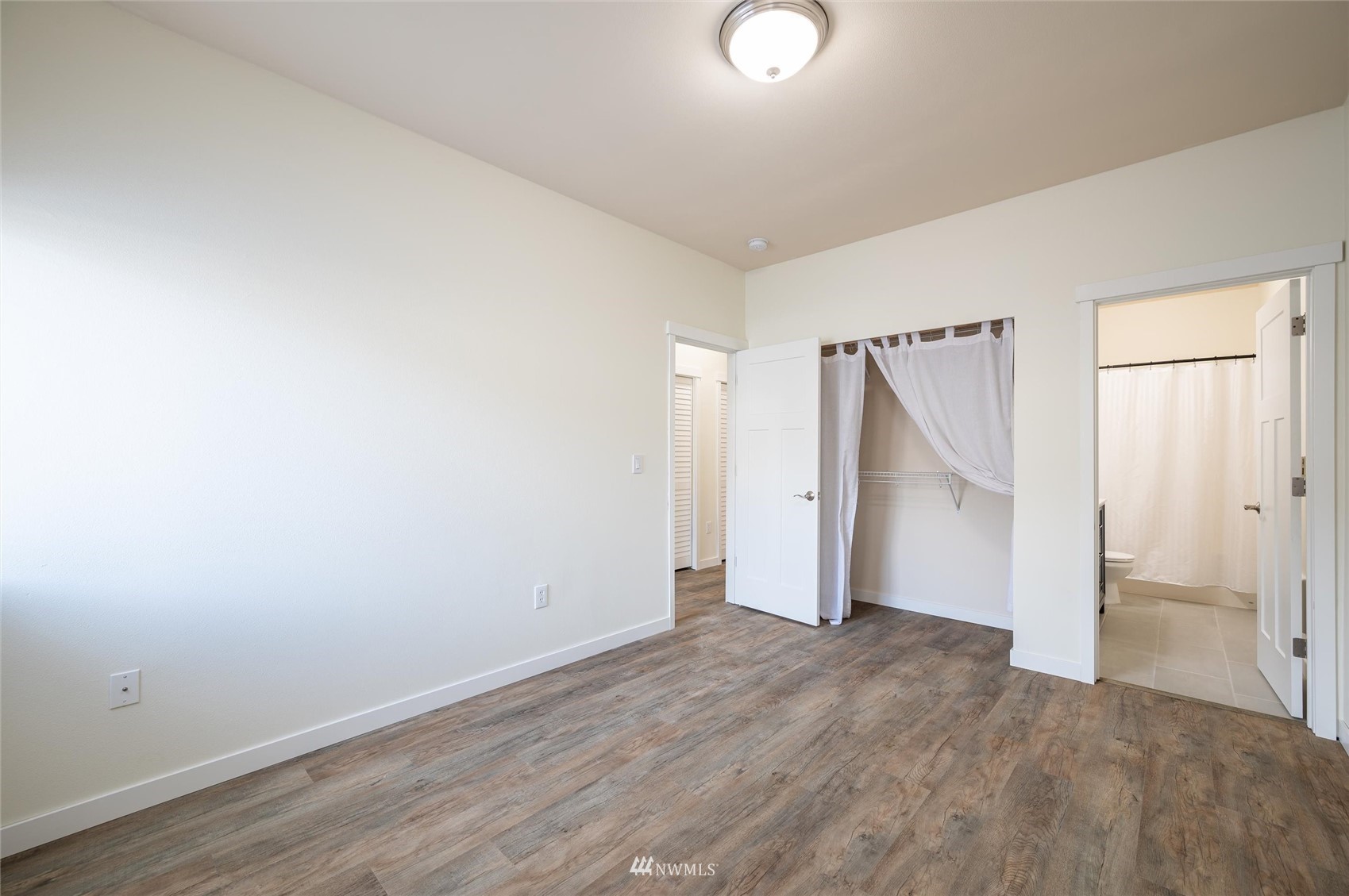 1305 Boon Street, Unit 122 Sumas, WA 98295 - Photo 9 of 21 an empty room with wooden floor and window