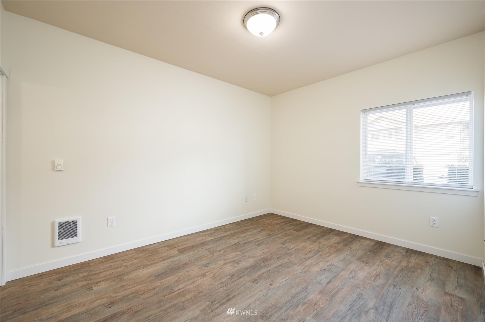 1305 Boon Street, Unit 122 Sumas, WA 98295 - Photo 10 of 21 an empty room with wooden floor and windows