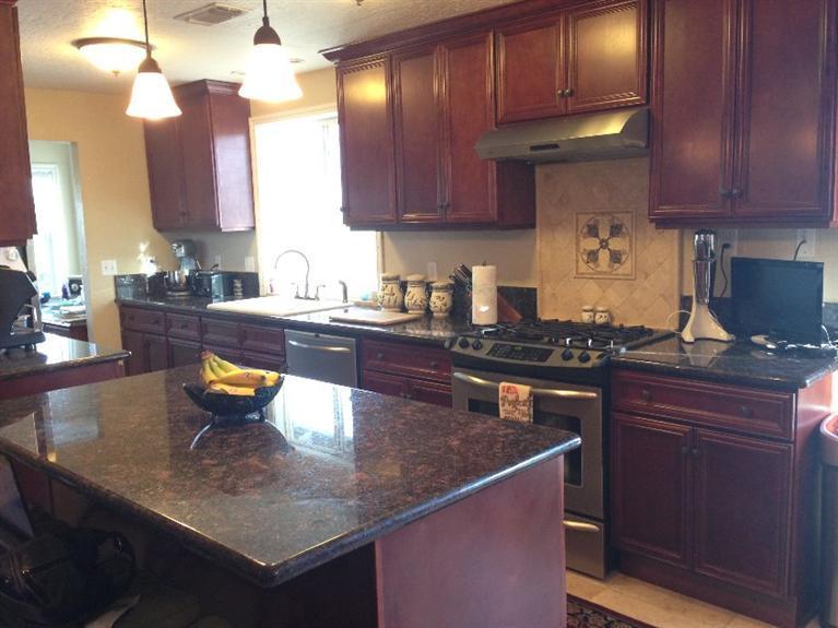 10083 Table Rock Road White City, OR 97503 - Photo 5 of 22 a kitchen with stainless steel appliances granite countertop a stove a sink dishwasher and cabinets with wooden floor