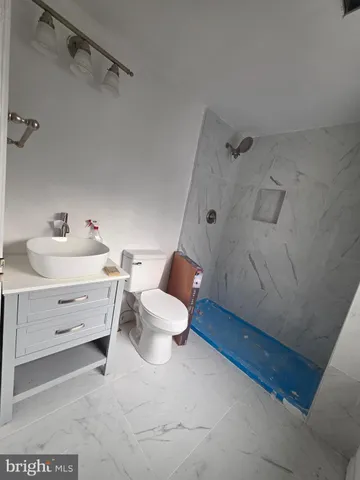 a bathroom with a sink mirror vanity and toilet