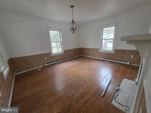 a view of a room with wooden floor and windows