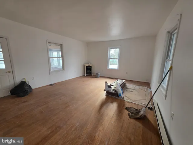 a bedroom with a bed and a wooden floor
