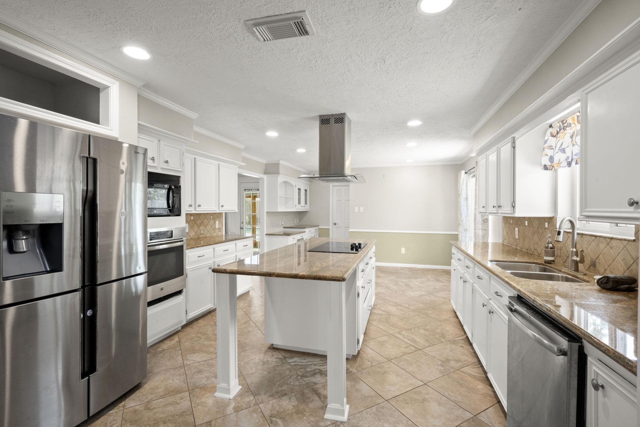 6607 Saffron Hills Drive Spring, TX 77379 - Photo 13 of 48 a large kitchen with kitchen island a sink stove and refrigerator