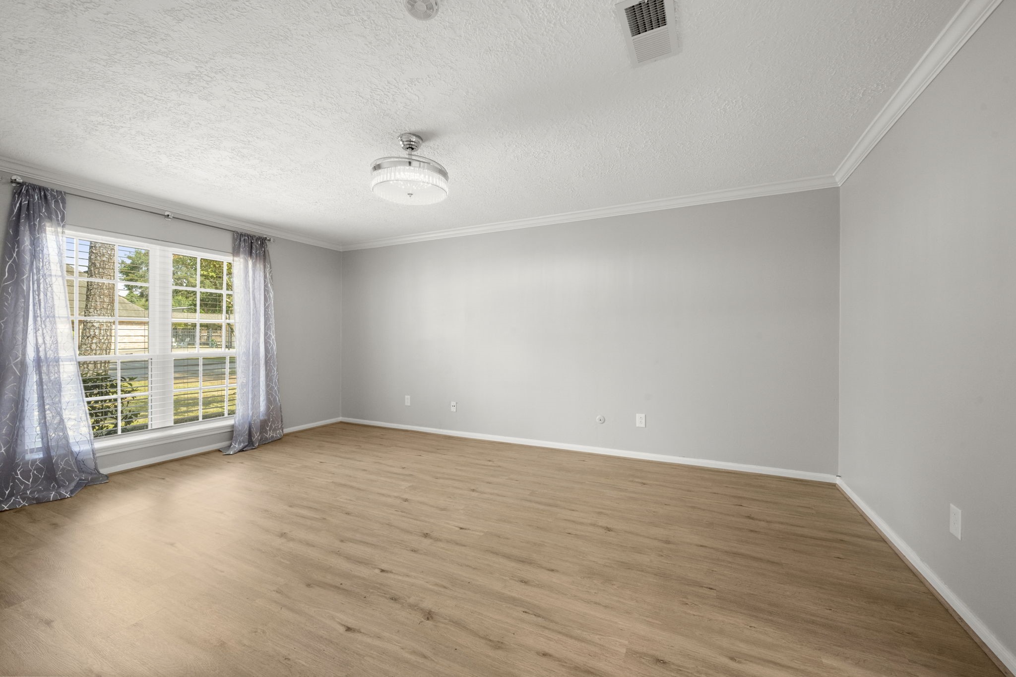 6607 Saffron Hills Drive Spring, TX 77379 - Photo 21 of 48 wooden floor in an empty room with a window