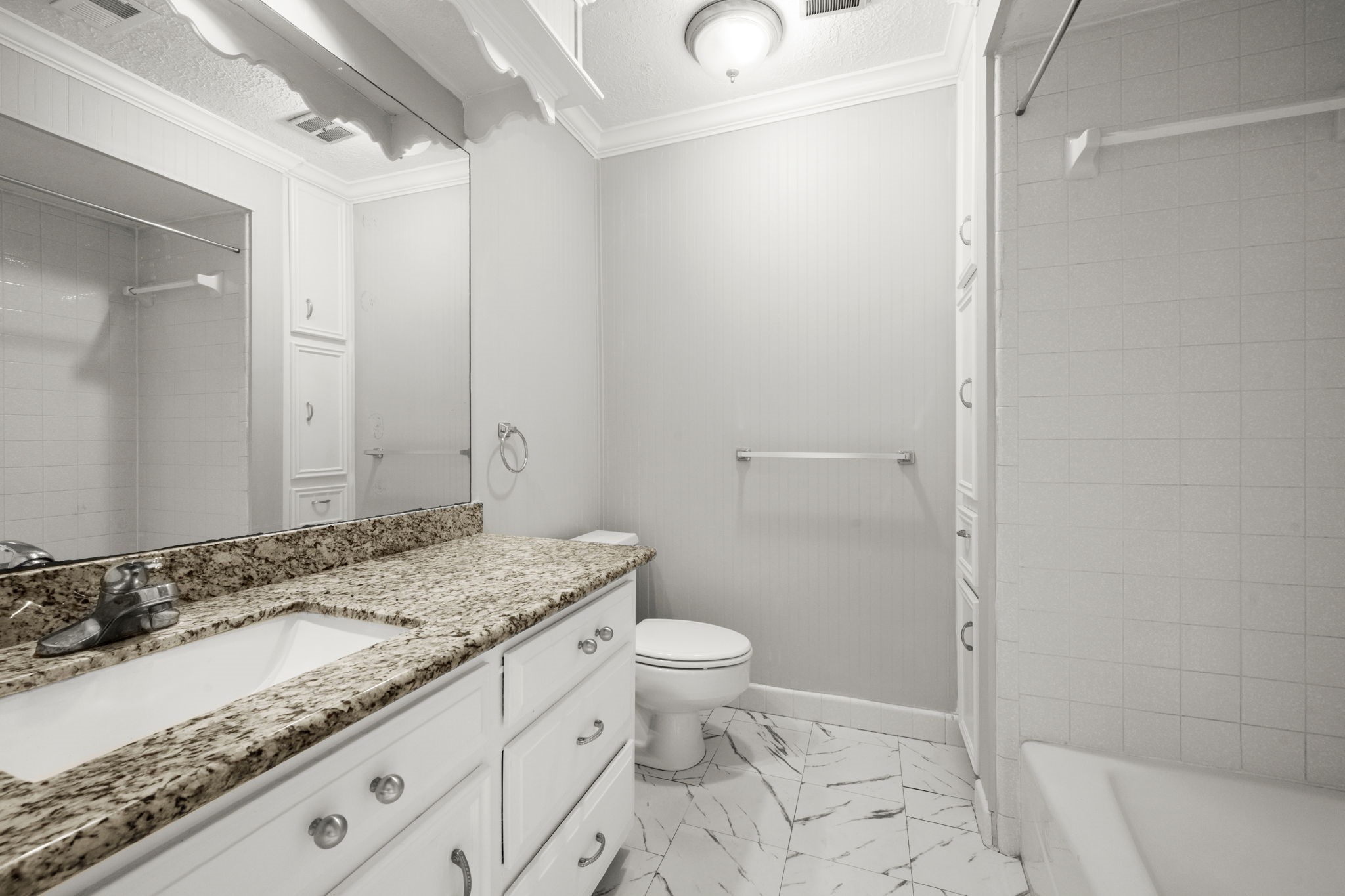 6607 Saffron Hills Drive Spring, TX 77379 - Photo 31 of 48 a bathroom with a granite countertop sink a toilet and a shower