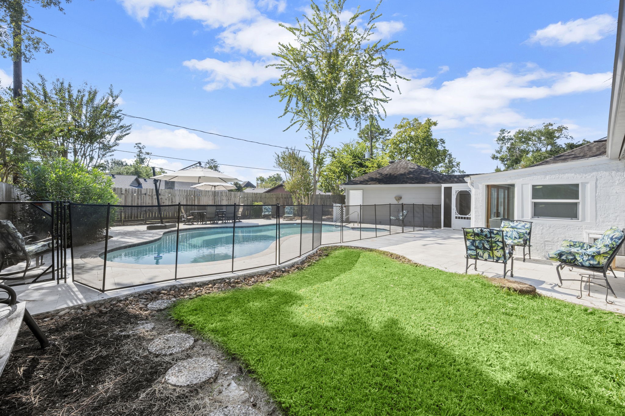 6607 Saffron Hills Drive Spring, TX 77379 - Photo 36 of 48 a view of a house with backyard and a garden