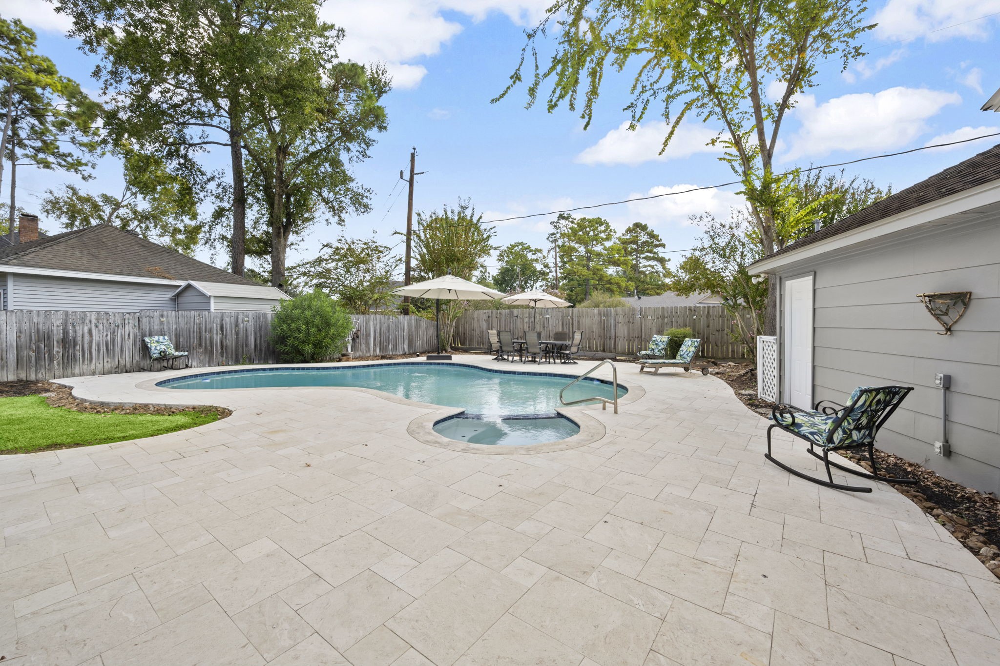 6607 Saffron Hills Drive Spring, TX 77379 - Photo 38 of 48 a view of a swimming pool with a patio and a yard