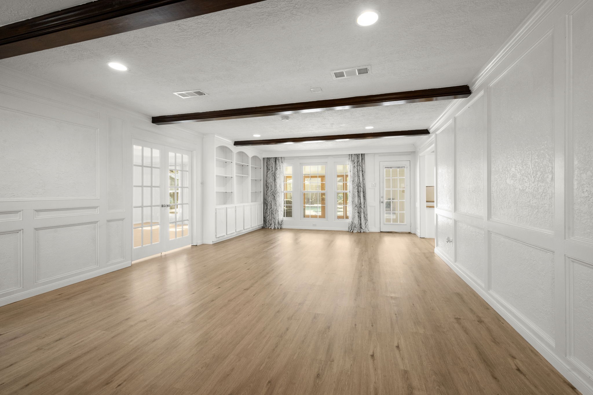 6607 Saffron Hills Drive Spring, TX 77379 - Photo 10 of 48 a view of an empty room with wooden floor and a window