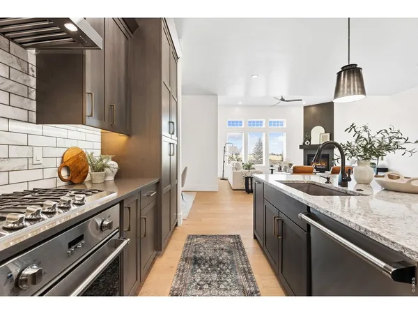 a kitchen with stainless steel appliances a sink stove and cabinets