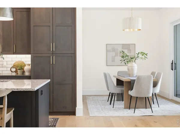 a dining room with furniture and wooden floor