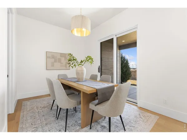a dining room with furniture and a window