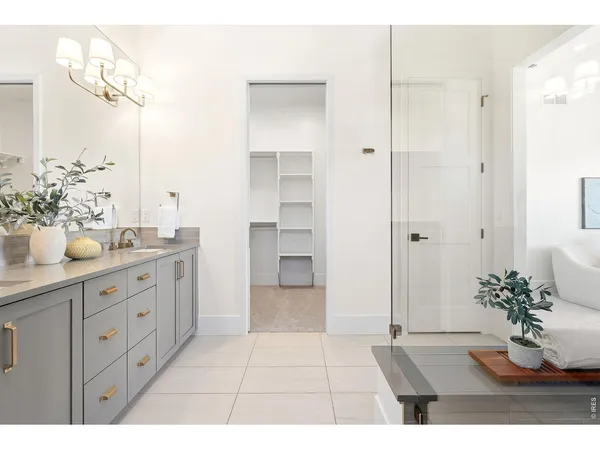 a spacious bathroom with a double vanity sink and a mirror