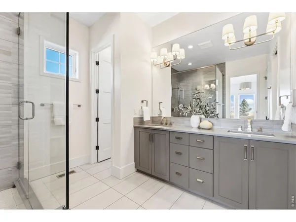 a bathroom with a granite countertop sink mirror and shower