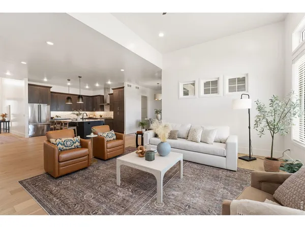 a living room with furniture and kitchen view