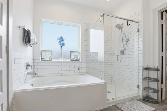 a bathroom with a bathtub and a shower