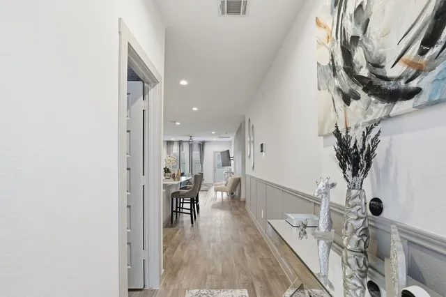 a dining room with furniture and wooden floor