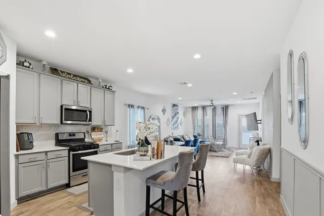 a kitchen with stainless steel appliances a microwave sink and refrigerator