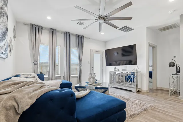 a bedroom with a large bed and a flat screen tv