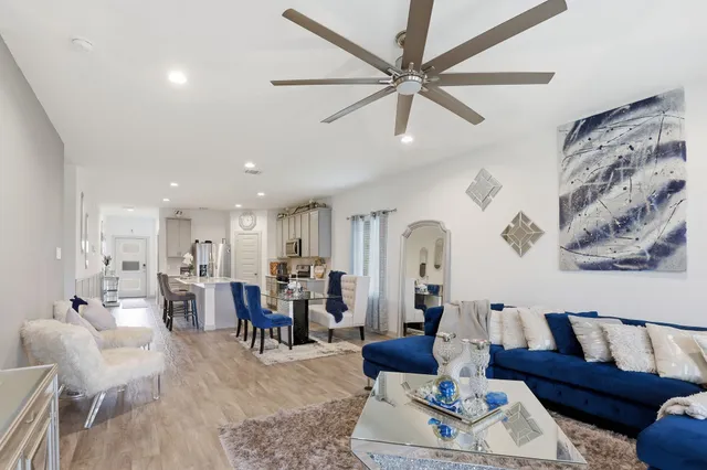 a living room with furniture and kitchen view