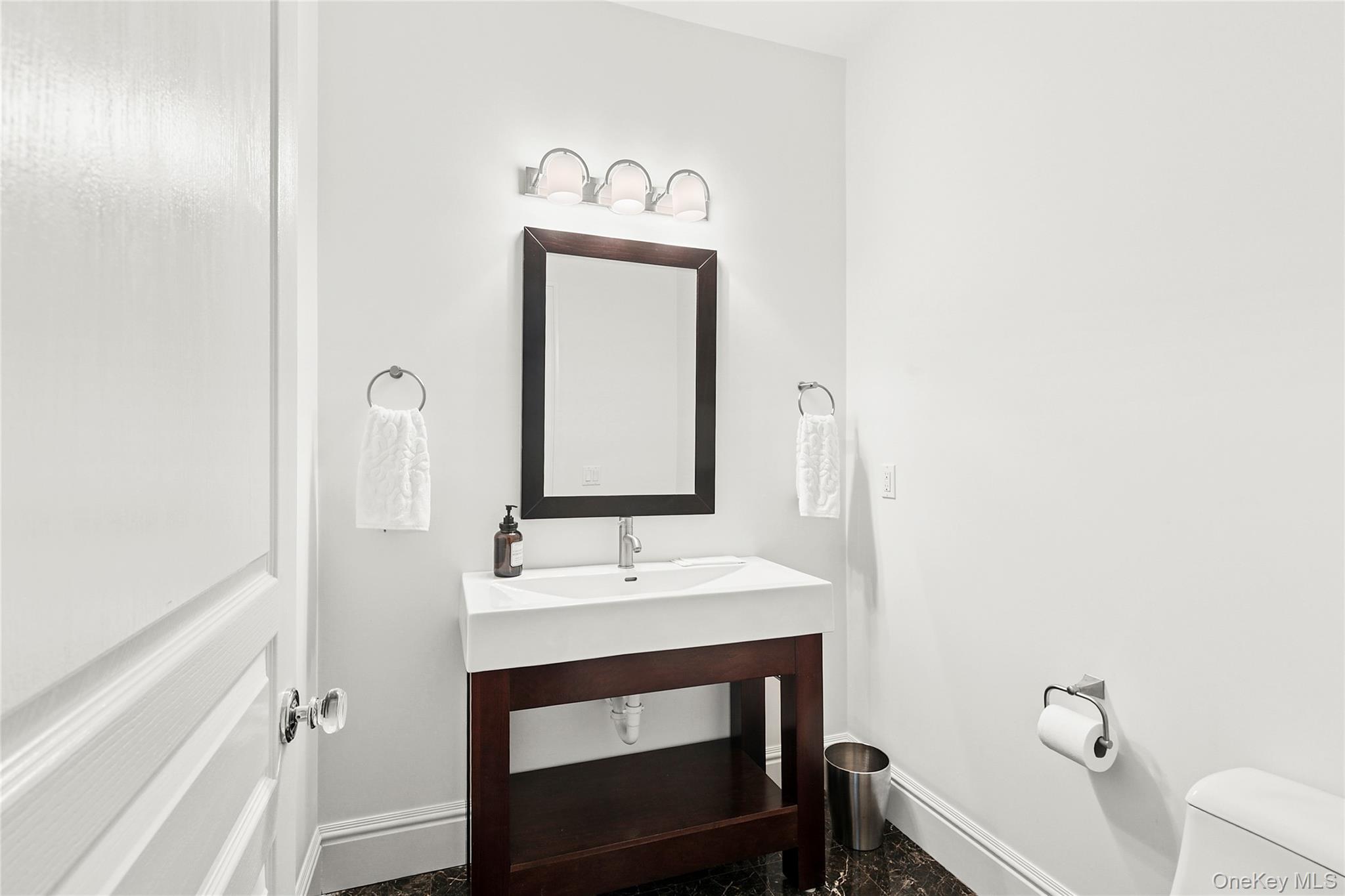 3470 North Bayview Road Southold, NY 11971 - Photo 10 of 25 Half bath with vanity and baseboards