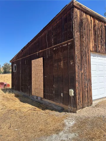 a view of a house with a wooden fence