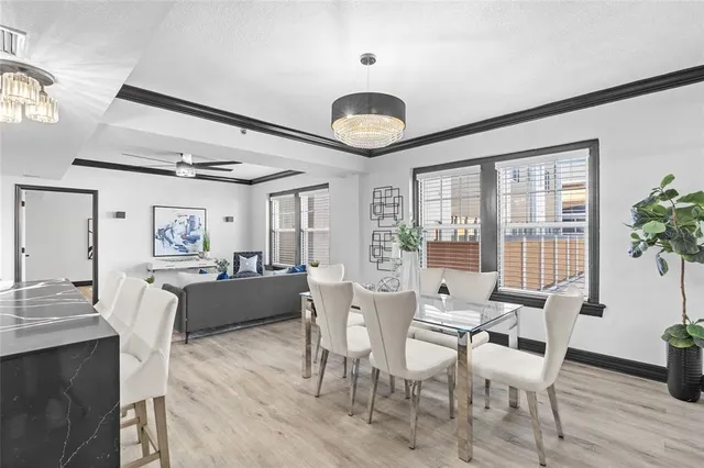a view of a dining room with furniture window and wooden floor