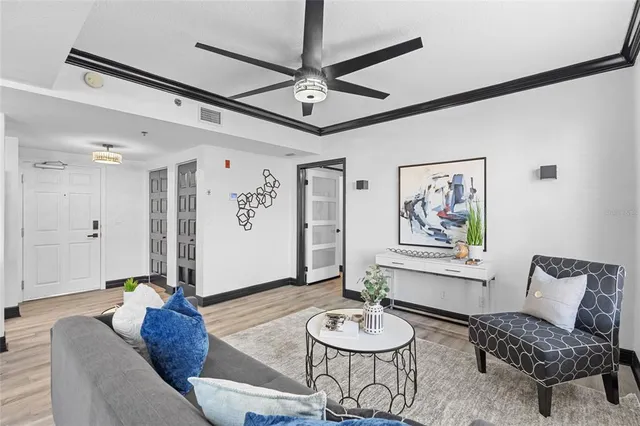 a living room with furniture and a wooden floor