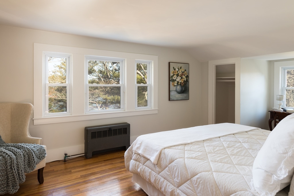 546 Wakeby Road Barnstable, MA 02648 - Photo 28 of 29 a bedroom with a bed and a window with wooden floor