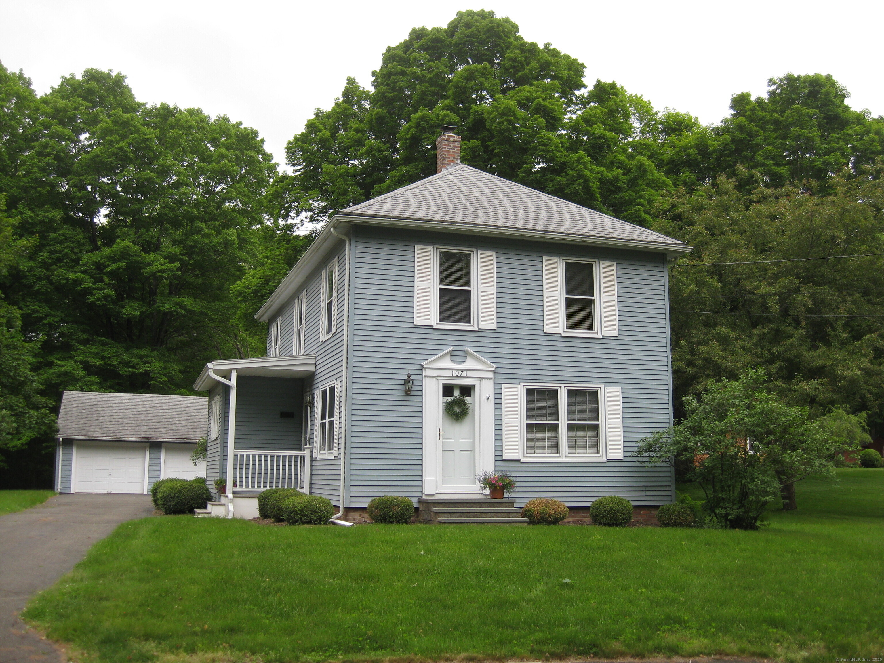 1071 River Boulevard Suffield, CT 06078 - Photo 1 of 1 a front view of a house with a yard and trees