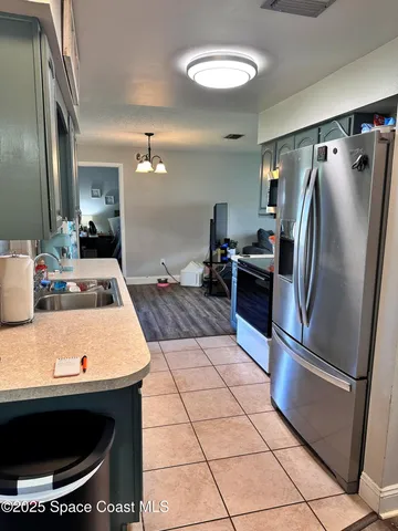 a kitchen with stainless steel appliances granite countertop a sink a stove and a refrigerator