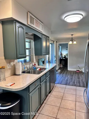 a kitchen with stainless steel appliances a sink stove and cabinets