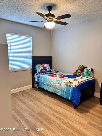 a bed sitting in a bedroom next to a window