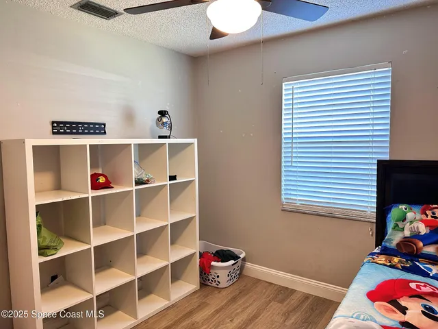 a room with a baby crib and a window