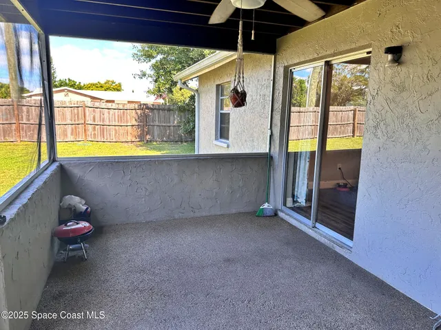a view of a room with a fireplace and a potted plant
