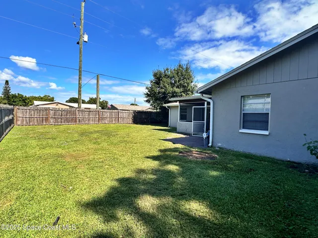a view of a house with a backyard porch and sitting area