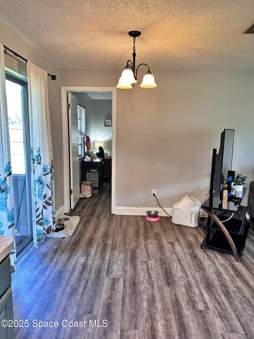 a room with wooden floor and furniture