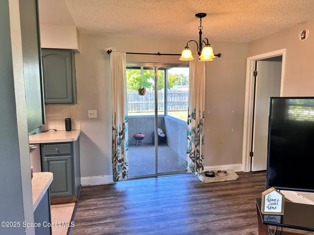 a view of a livingroom with furniture window and wooden floor