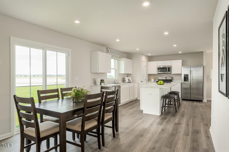 4160 Dragonfly Road Bailey, NC 27807 - Photo 3 of 5 a view of a dining room with furniture and wooden floor