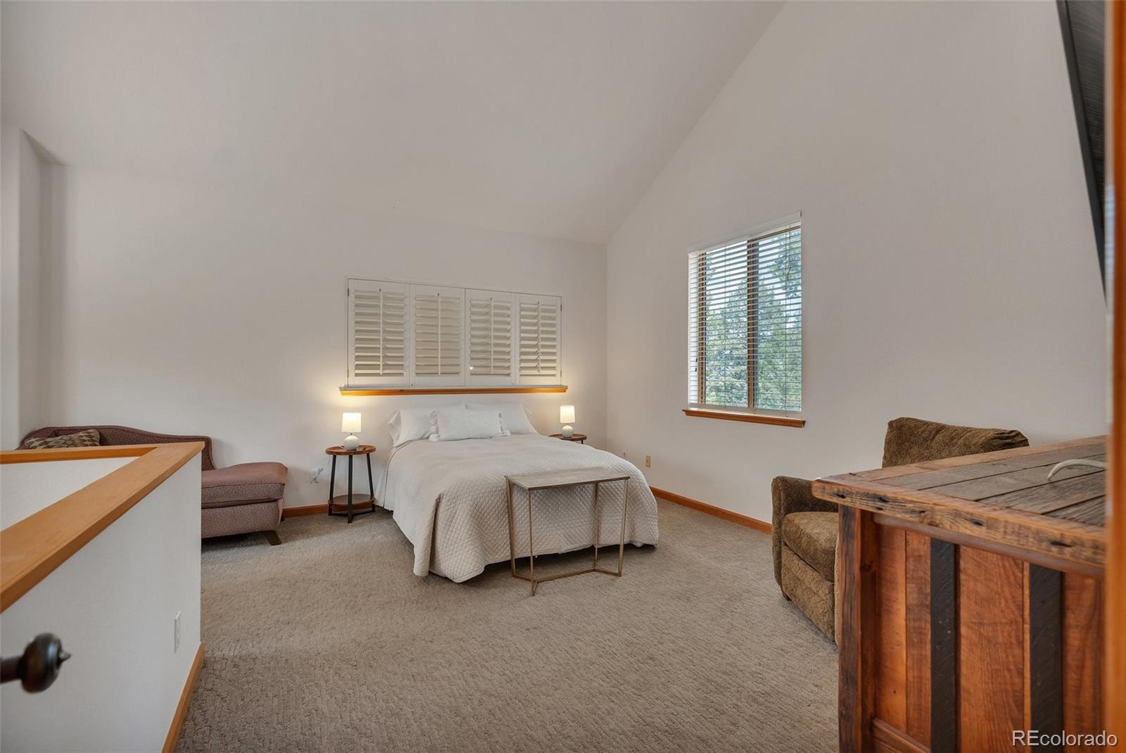 9590 South Warhawk Road Conifer, CO 80433 - Photo 25 of 43 a bedroom with a bed and a window